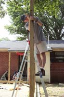 Becca and Jim getting ready to cut the tops off of the posts.